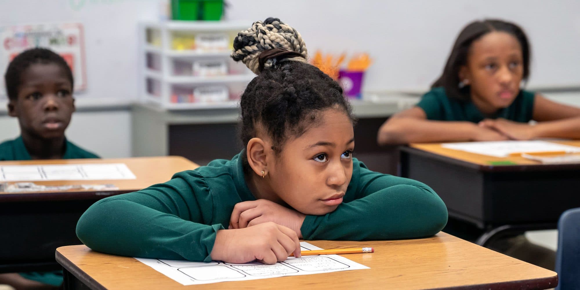 Students listening at their desks during a lesson.